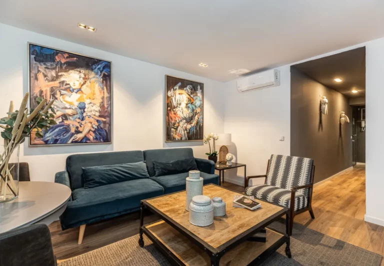 Sofá de terciopelo azul y mesa de centro en el apartamento Queen's Chueca I, Madrid