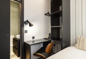 Escritorio con silla de cuero y estantería negra, Queen's Coliving Chamberí I, coliving en Ríos Rosas, Chamberí, Madrid